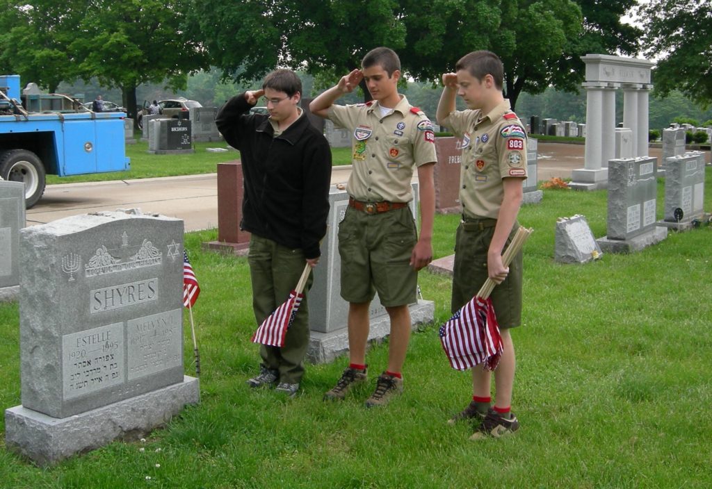 Boy Scouts placing flags at Veteran grave sites
